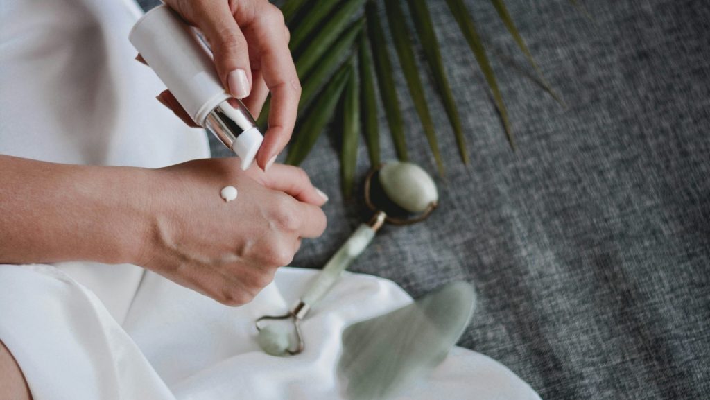 person holding white plastic bottle pouring white liquid on white ceramic mug